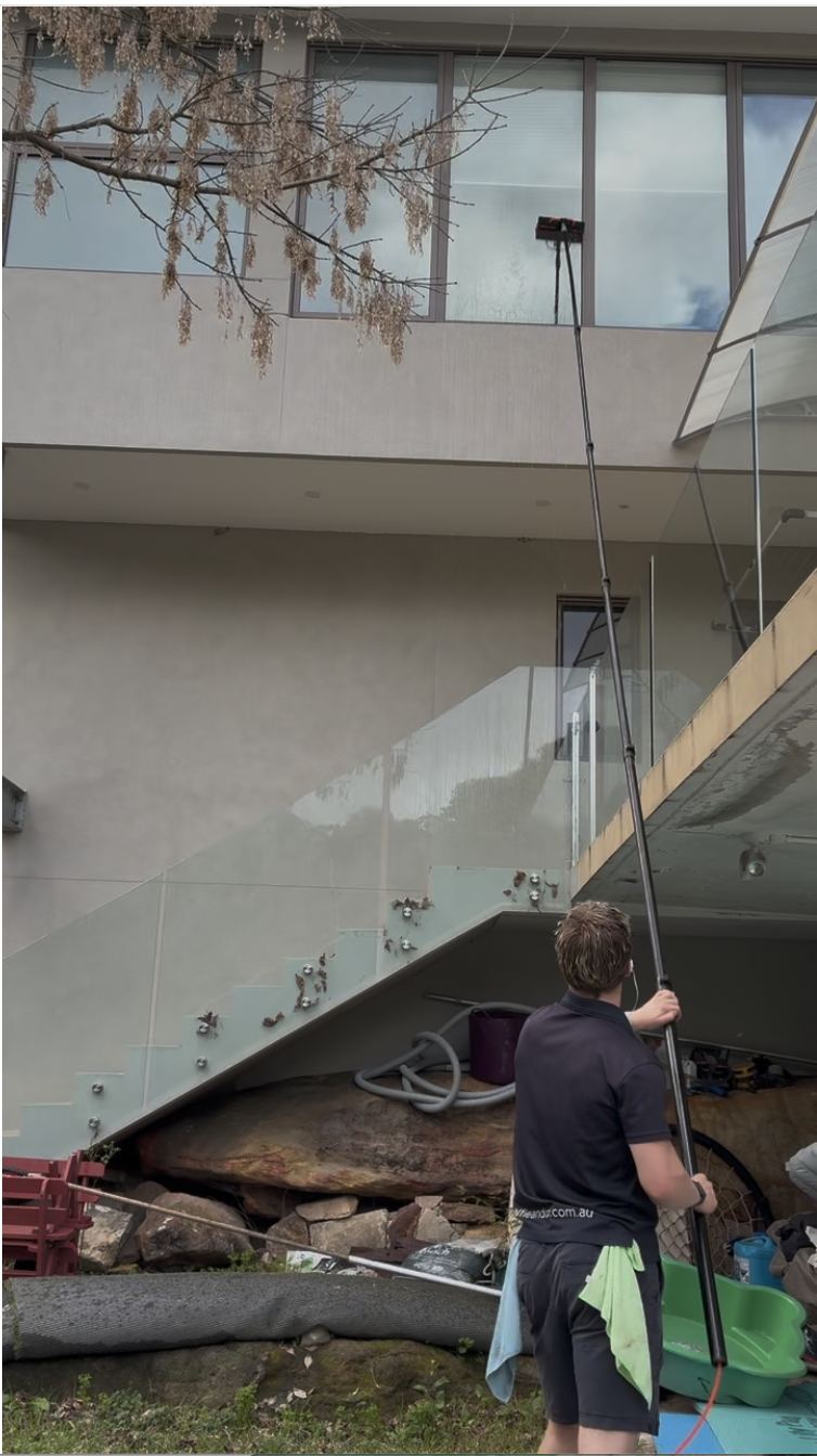 Cleaning high windows with a water-fed pole