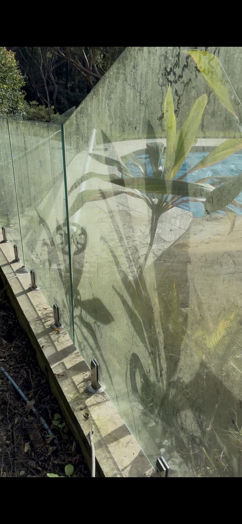 Pool fence glass before cleaning